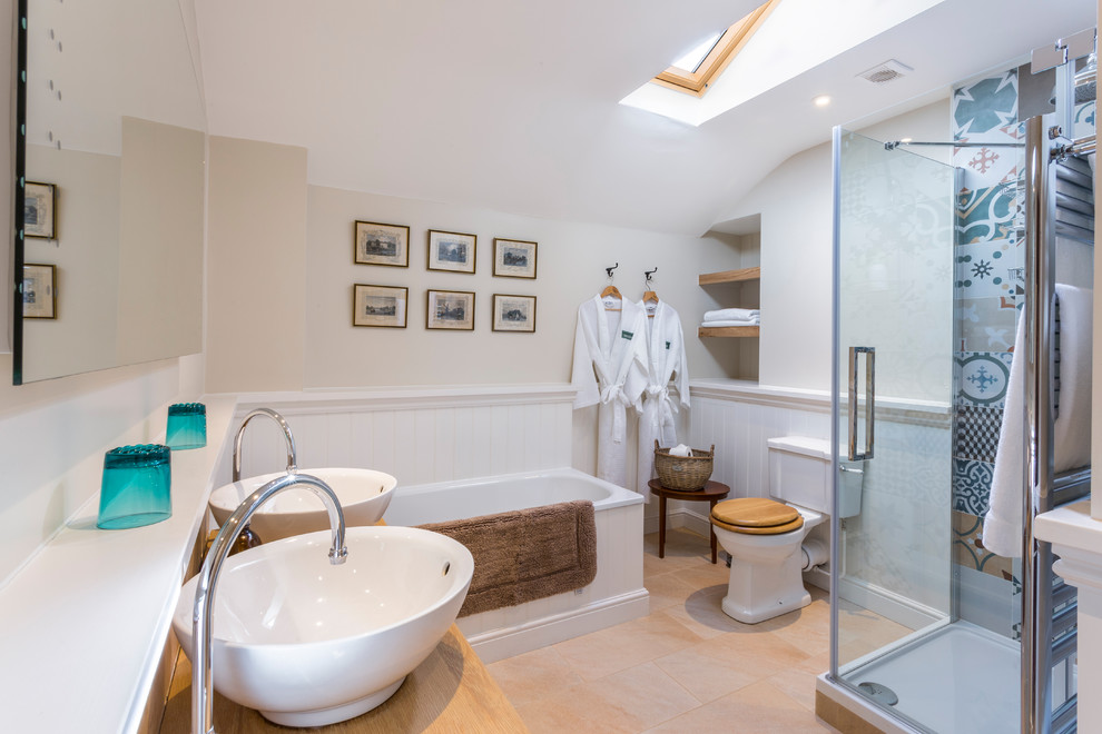 Medium sized country shower room bathroom in London with medium wood cabinets, a corner bath, a corner shower, a two-piece toilet, beige walls, a vessel sink, wooden worktops, beige floors, a hinged door and brown worktops.