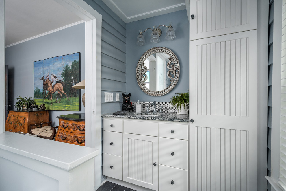 Inredning av ett maritimt mellanstort en-suite badrum, med möbel-liknande, vita skåp, ett badkar med tassar, vit kakel, mosaik, blå väggar, skiffergolv, ett undermonterad handfat, granitbänkskiva och blått golv