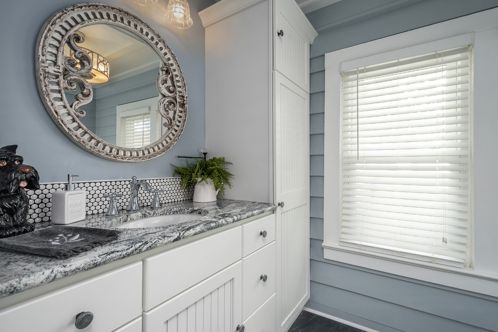 Photo of a medium sized nautical ensuite bathroom in Orlando with freestanding cabinets, white cabinets, a claw-foot bath, white tiles, mosaic tiles, blue walls, slate flooring, a submerged sink, granite worktops and blue floors.