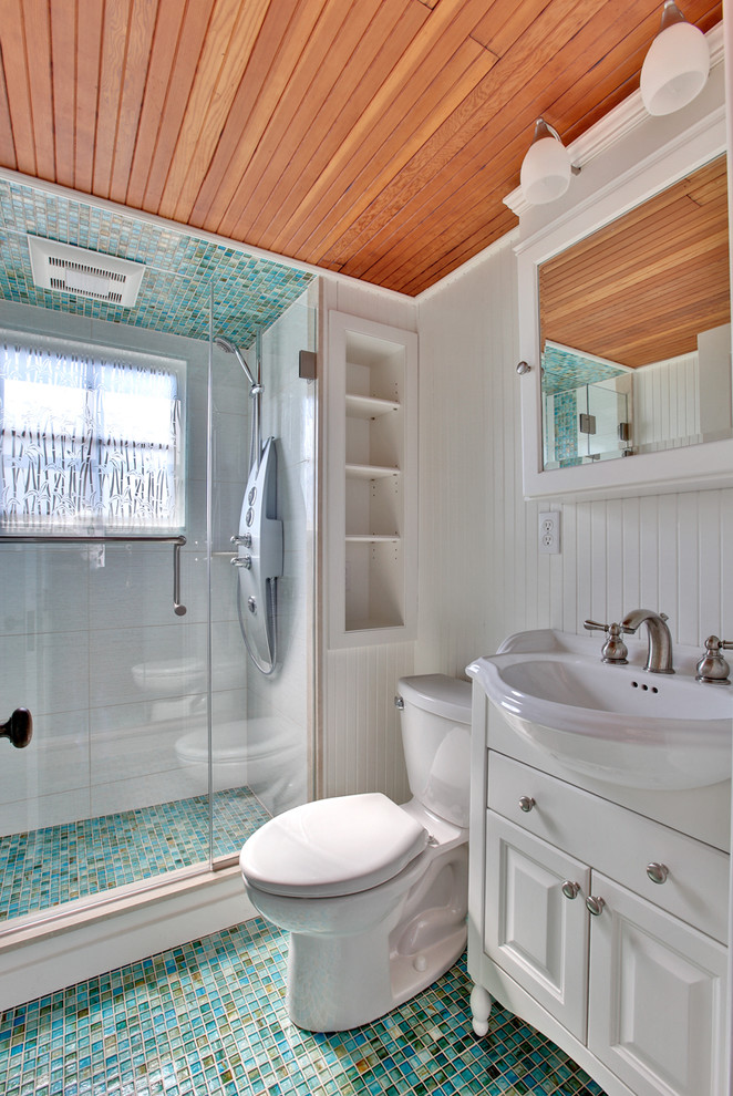 Photo of a medium sized classic ensuite bathroom in New York with beaded cabinets, white cabinets, a corner shower, a one-piece toilet, white walls, mosaic tile flooring and a built-in sink.