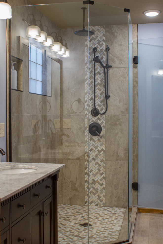 Small transitional master beige tile and mosaic tile ceramic tile corner shower photo in Other with furniture-like cabinets, brown cabinets, a one-piece toilet, blue walls, an undermount sink and granite countertops