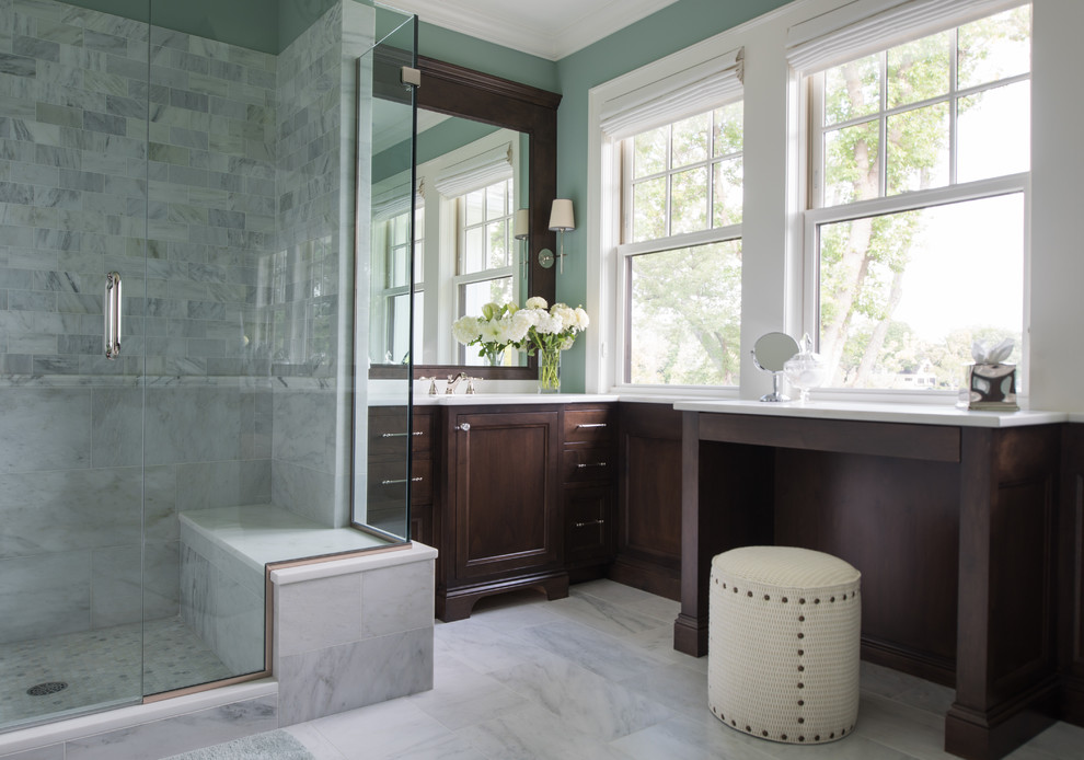 Inspiration for a mid-sized transitional master gray tile and porcelain tile marble floor and gray floor alcove shower remodel in Minneapolis with recessed-panel cabinets, dark wood cabinets, gray walls, an undermount sink, solid surface countertops and a hinged shower door