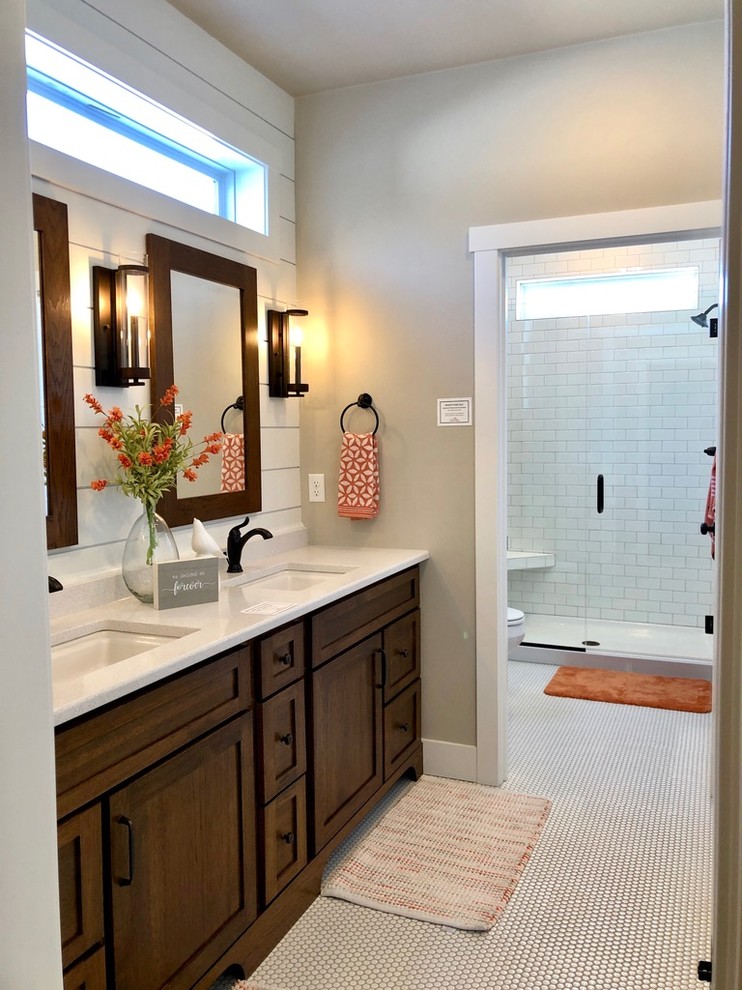 Example of a large farmhouse master mosaic tile floor and white floor bathroom design in Other with shaker cabinets, dark wood cabinets, a one-piece toilet, gray walls, an undermount sink, quartz countertops, a hinged shower door and white countertops