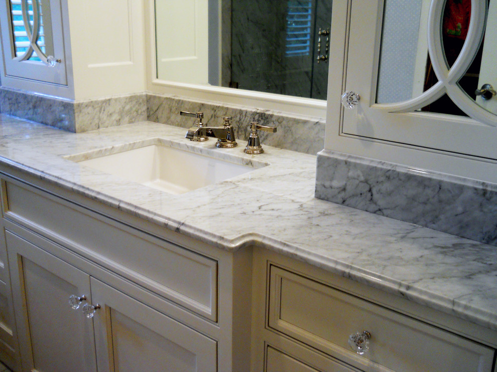 Mid-sized country master white tile and mosaic tile marble floor bathroom photo in Chicago with a drop-in sink, recessed-panel cabinets, white cabinets, marble countertops, a one-piece toilet and white walls