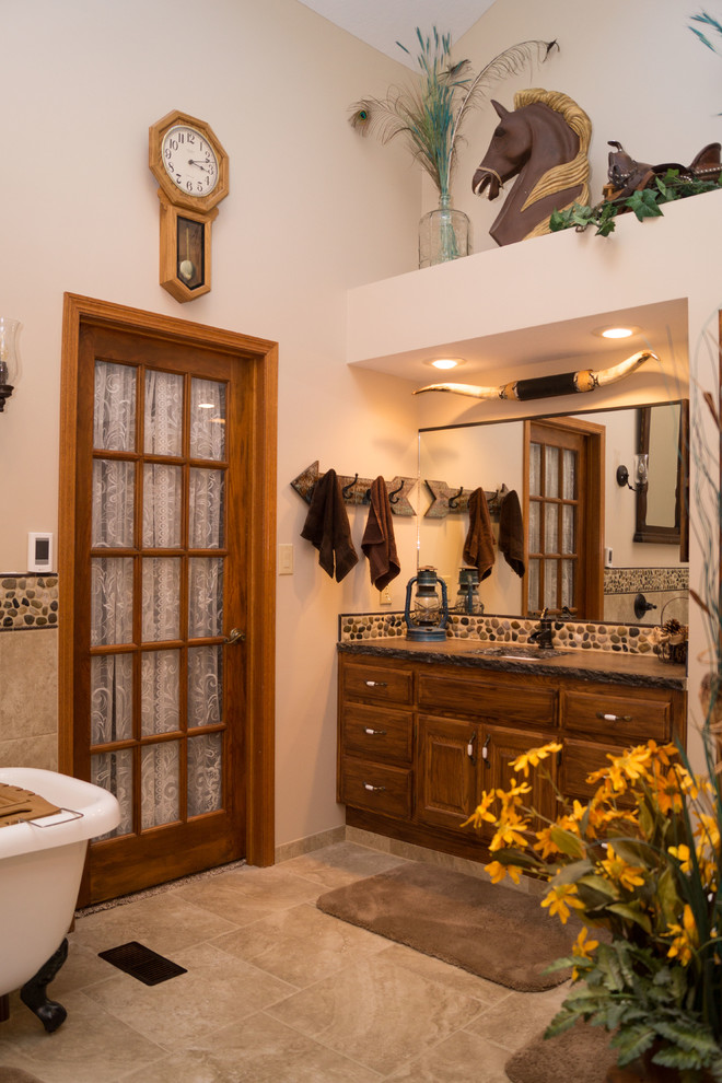 Example of a large southwest master multicolored tile and ceramic tile ceramic tile bathroom design in Other with raised-panel cabinets, medium tone wood cabinets, a two-piece toilet, beige walls, an undermount sink and concrete countertops