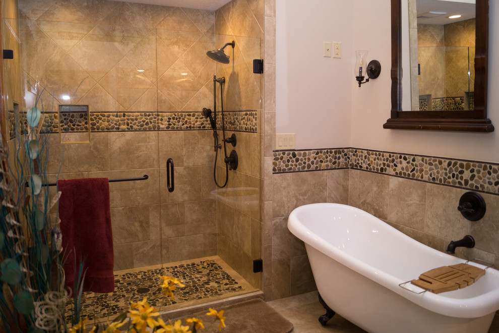 Photo of a large ensuite bathroom in Other with raised-panel cabinets, medium wood cabinets, a claw-foot bath, an alcove shower, a two-piece toilet, multi-coloured tiles, ceramic tiles, beige walls, ceramic flooring, a submerged sink and concrete worktops.