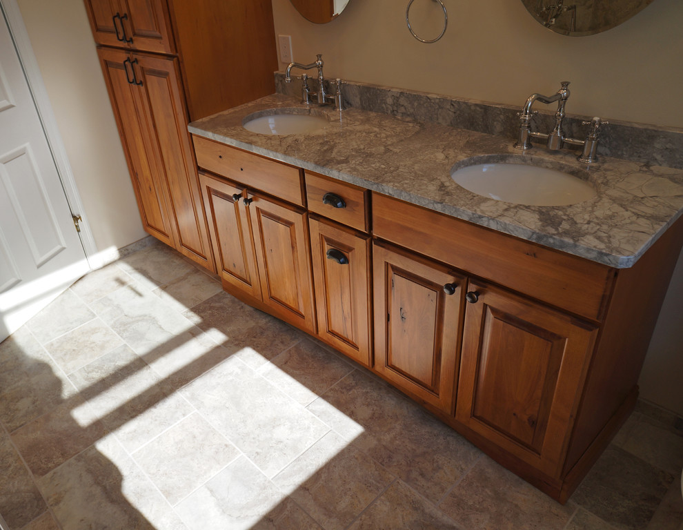 Bathroom - mid-sized traditional master beige tile and porcelain tile porcelain tile bathroom idea in Philadelphia with an undermount sink, raised-panel cabinets, medium tone wood cabinets, granite countertops, a two-piece toilet and beige walls
