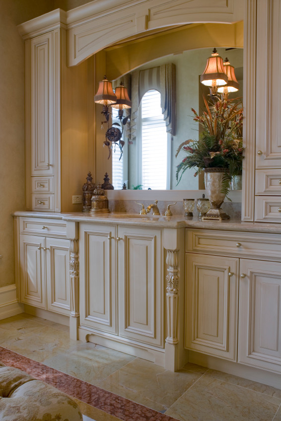 Inredning av ett klassiskt stort bastu, med luckor med upphöjd panel, beige skåp, ett platsbyggt badkar, en toalettstol med hel cisternkåpa, beige kakel, stenkakel, beige väggar, marmorgolv, ett undermonterad handfat och marmorbänkskiva