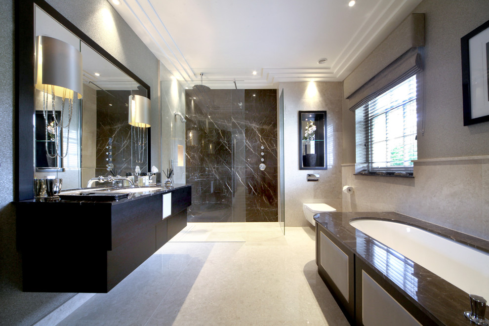 Design ideas for a large contemporary ensuite bathroom in Kent with freestanding cabinets, dark wood cabinets, a built-in bath, a walk-in shower, beige tiles, porcelain tiles, beige walls, marble flooring and marble worktops.