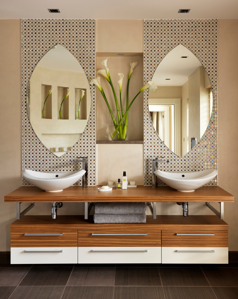 Example of a large trendy master multicolored tile and mosaic tile bathroom design in London with a vessel sink and beige walls