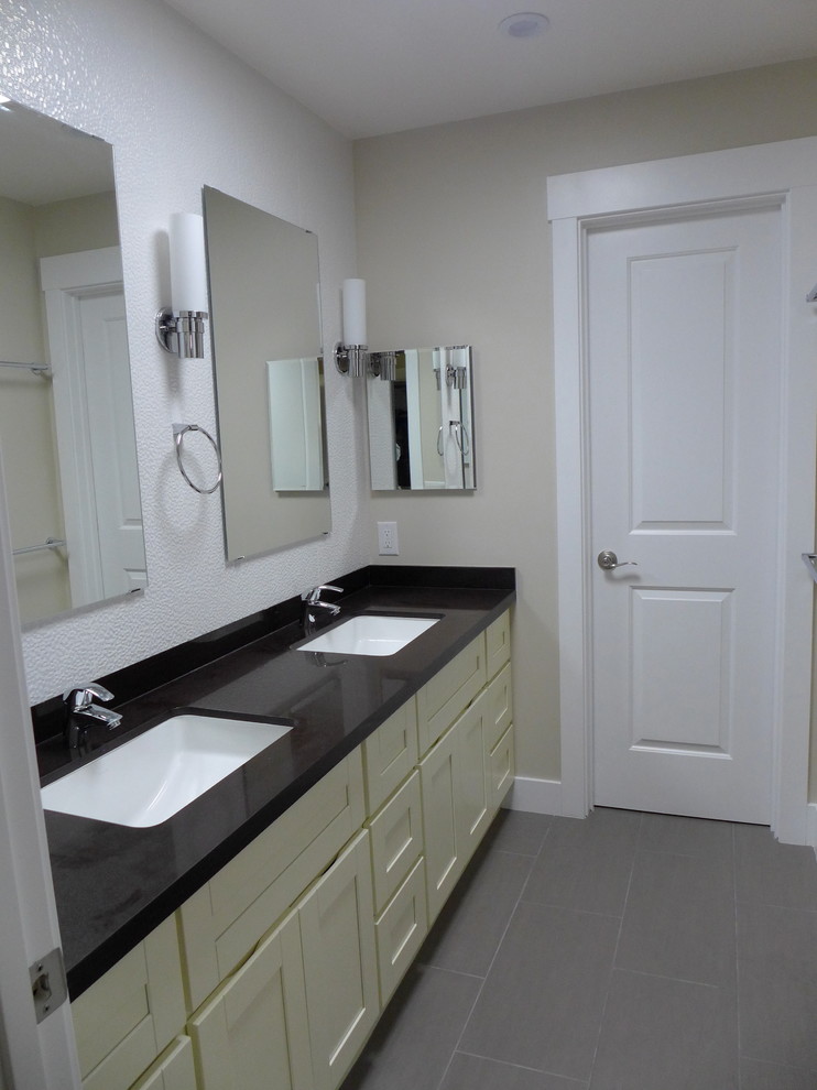 Small contemporary ensuite bathroom in San Francisco with shaker cabinets, brown cabinets, an alcove shower, a one-piece toilet, white tiles, stone slabs, white walls, porcelain flooring, a built-in sink, engineered stone worktops, grey floors, a sliding door, white worktops, an enclosed toilet, double sinks and a built in vanity unit.