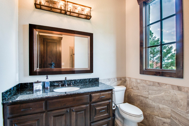 Photo of a rustic ensuite bathroom in Dallas with beaded cabinets, white cabinets, an alcove bath, an alcove shower, beige tiles, beige walls, medium hardwood flooring, a submerged sink, brown floors and a hinged door.