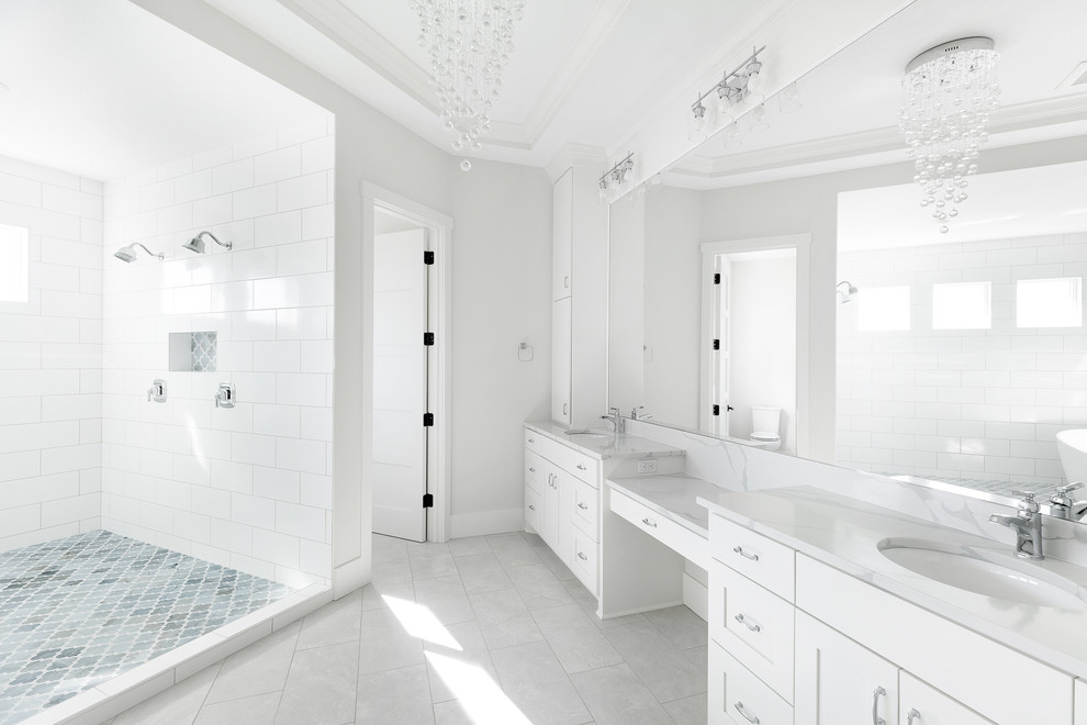 Inspiration for a large traditional ensuite wet room bathroom in Minneapolis with shaker cabinets, white cabinets, a freestanding bath, white tiles, grey walls, a submerged sink, quartz worktops, an open shower, white worktops, grey floors, porcelain flooring, a two-piece toilet and ceramic tiles.