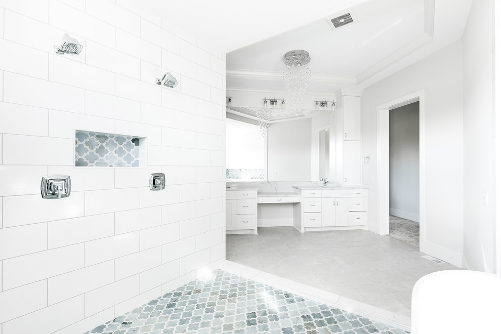 Large classic ensuite wet room bathroom in Minneapolis with shaker cabinets, white cabinets, a freestanding bath, white tiles, grey walls, a submerged sink, quartz worktops, an open shower, white worktops, grey floors, a two-piece toilet, ceramic tiles and porcelain flooring.
