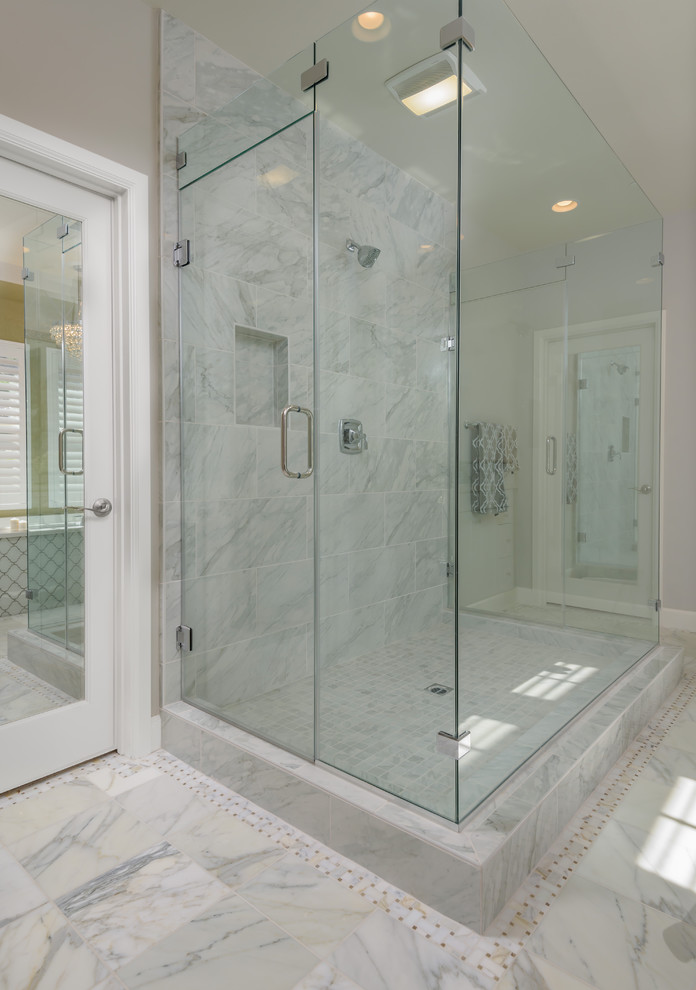 Bathroom - large contemporary master black and white tile and stone tile marble floor and gray floor bathroom idea in Orange County with raised-panel cabinets, white cabinets, white walls, an undermount sink, solid surface countertops, a two-piece toilet and a hinged shower door