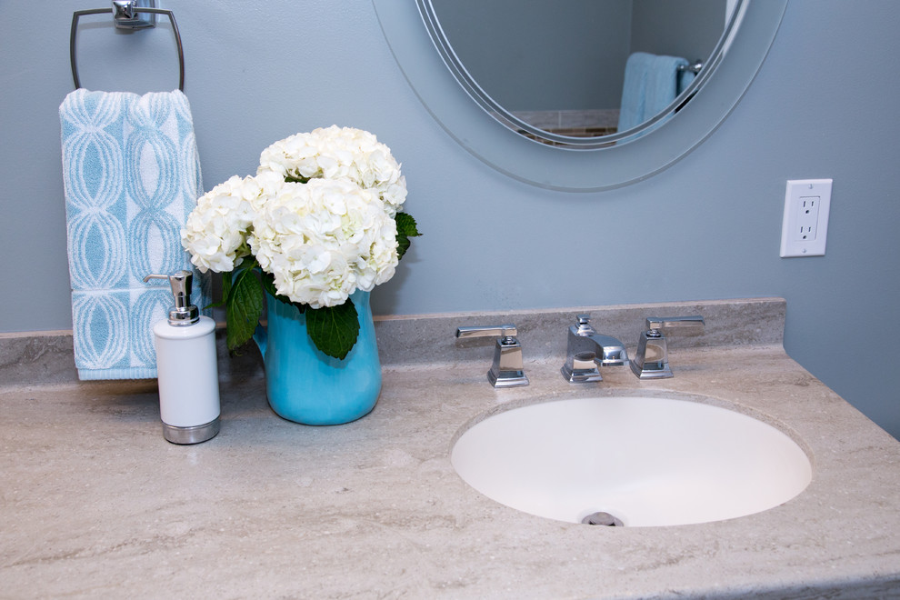 Aménagement d'une salle de bain contemporaine de taille moyenne avec un lavabo encastré, un placard avec porte à panneau surélevé, des portes de placard blanches, un plan de toilette en surface solide, une douche d'angle, un carrelage multicolore et un mur bleu.
