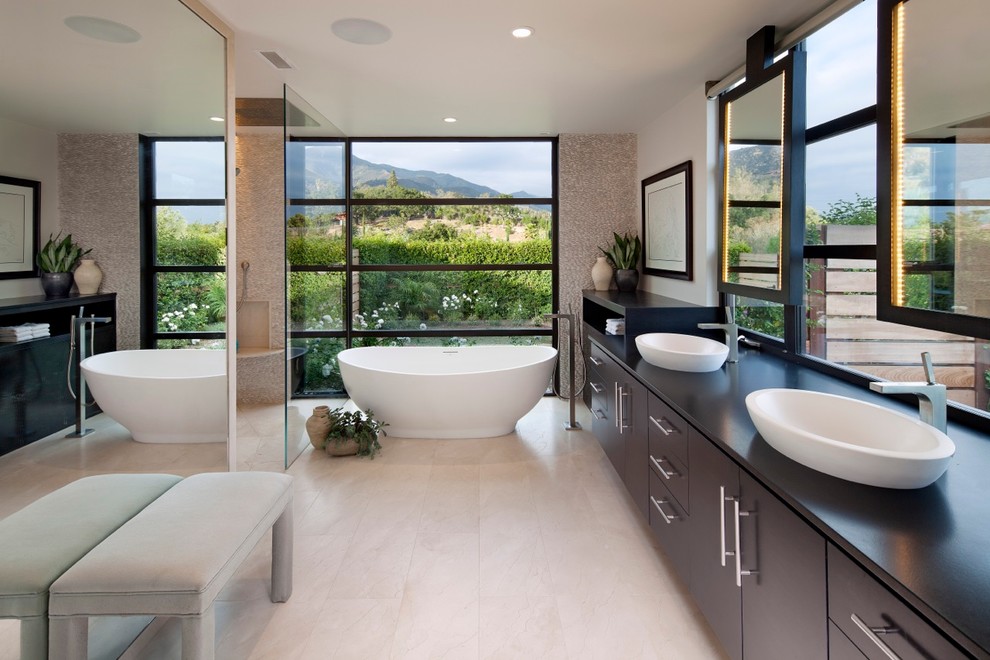 Design ideas for a contemporary ensuite bathroom in Santa Barbara with a vessel sink, flat-panel cabinets, dark wood cabinets, a freestanding bath and a built-in shower.
