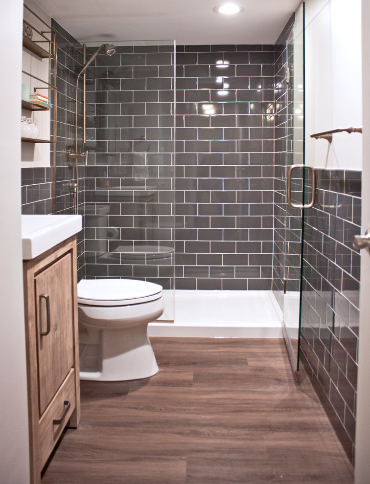 Example of a small transitional 3/4 gray tile and ceramic tile vinyl floor alcove shower design in Chicago with flat-panel cabinets, distressed cabinets, a two-piece toilet, gray walls, an integrated sink, a hinged shower door and white countertops