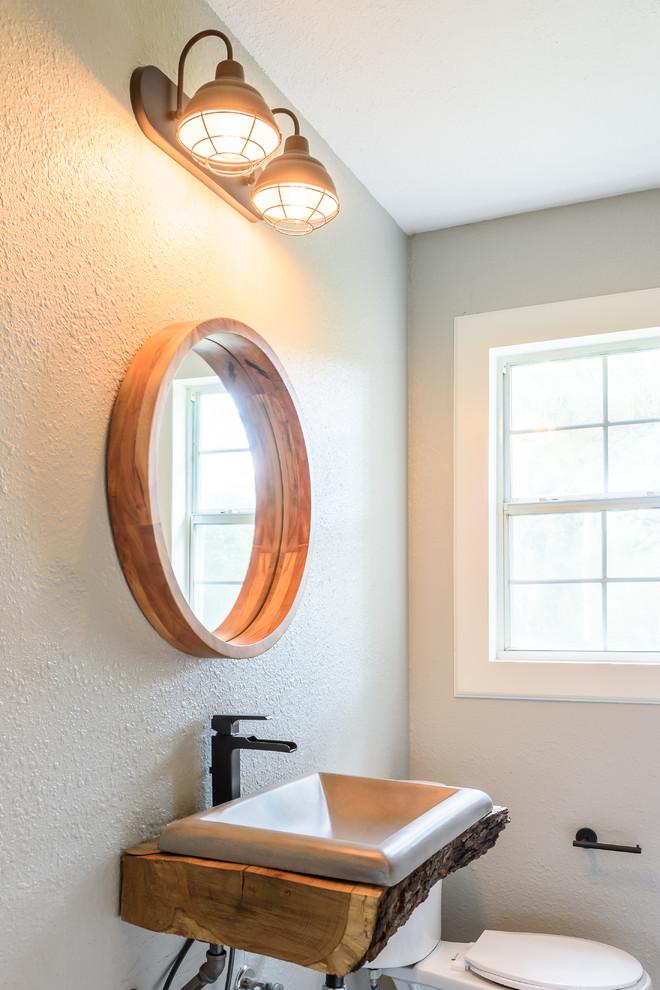 Inredning av ett rustikt litet brun brunt badrum med dusch, med ett badkar i en alkov, en dusch/badkar-kombination, en toalettstol med separat cisternkåpa, grå väggar, mörkt trägolv, ett nedsänkt handfat, träbänkskiva, brunt golv och dusch med skjutdörr
