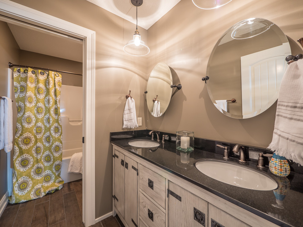 Example of a large transitional kids' brown tile dark wood floor bathroom design in Indianapolis with a two-piece toilet, beige walls, an undermount sink, flat-panel cabinets, white cabinets and solid surface countertops
