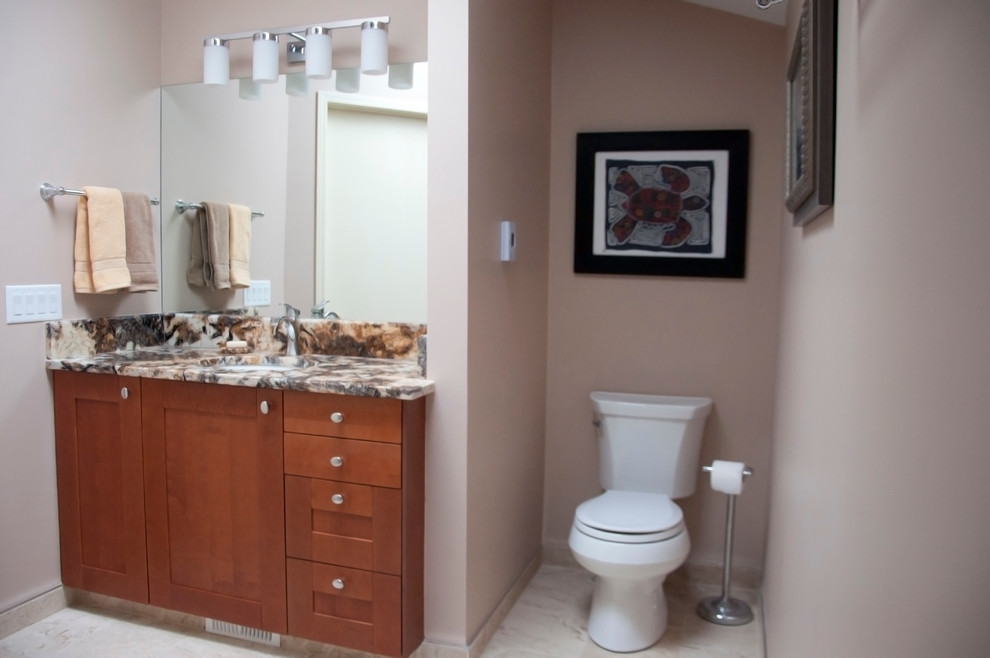 Inspiration for a mid-sized transitional master beige tile and ceramic tile ceramic tile bathroom remodel in Calgary with shaker cabinets, medium tone wood cabinets, beige walls, a two-piece toilet, an undermount sink and granite countertops