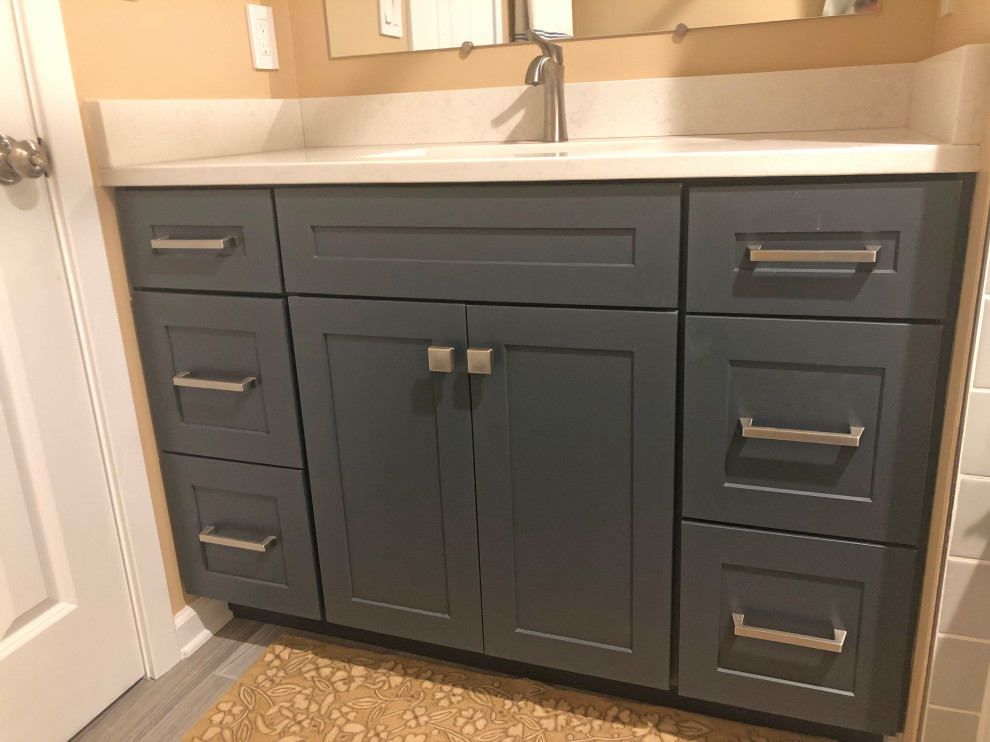 Small transitional kids' gray tile and ceramic tile porcelain tile, gray floor and single-sink bathroom photo in Baltimore with shaker cabinets, blue cabinets, a two-piece toilet, beige walls, an undermount sink, quartz countertops, beige countertops and a built-in vanity