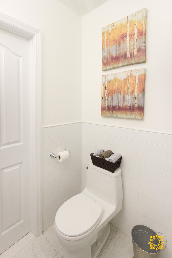 Photo of a medium sized traditional cloakroom in New York with an integrated sink, glass-front cabinets, a one-piece toilet, white tiles, white walls, porcelain flooring, dark wood cabinets, porcelain tiles and engineered stone worktops.