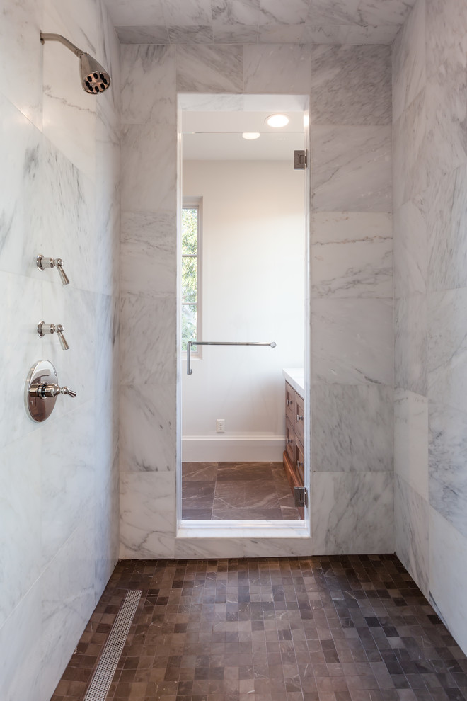 Design ideas for a large traditional ensuite bathroom in Houston with recessed-panel cabinets, medium wood cabinets, a freestanding bath, an alcove shower, white tiles, marble tiles, white walls, marble flooring, brown floors, a hinged door and white worktops.