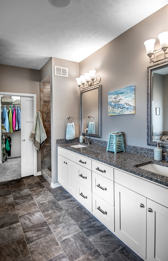 This is an example of a medium sized classic ensuite bathroom in Omaha with a submerged sink, shaker cabinets, white cabinets, granite worktops, an alcove bath, an alcove shower, a two-piece toilet, grey walls, lino flooring, brown tiles, grey floors and an open shower.