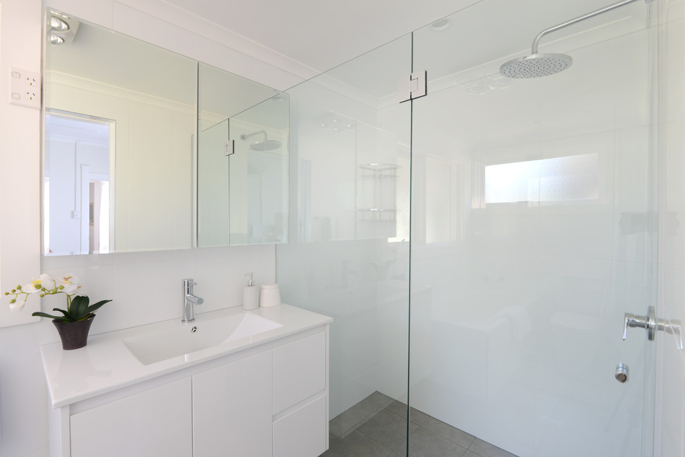Inspiration for a mid-sized contemporary kids' gray tile and ceramic tile ceramic tile bathroom remodel in Sydney with an integrated sink, white cabinets and white walls