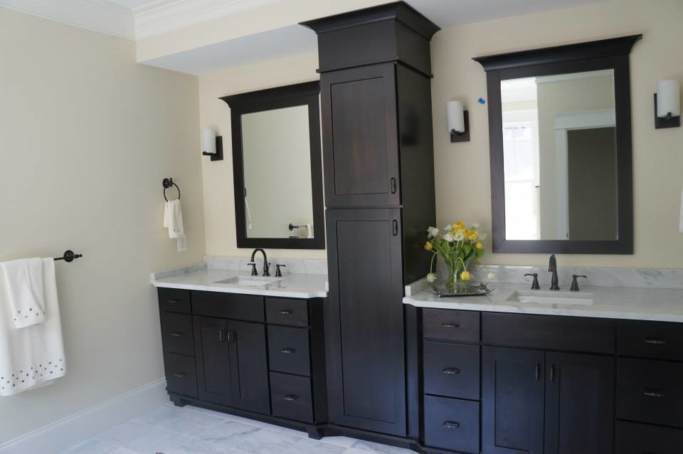 This is an example of a traditional ensuite bathroom in DC Metro with an integrated sink, flat-panel cabinets, dark wood cabinets, granite worktops, an alcove bath, a one-piece toilet, grey tiles, beige walls and marble flooring.