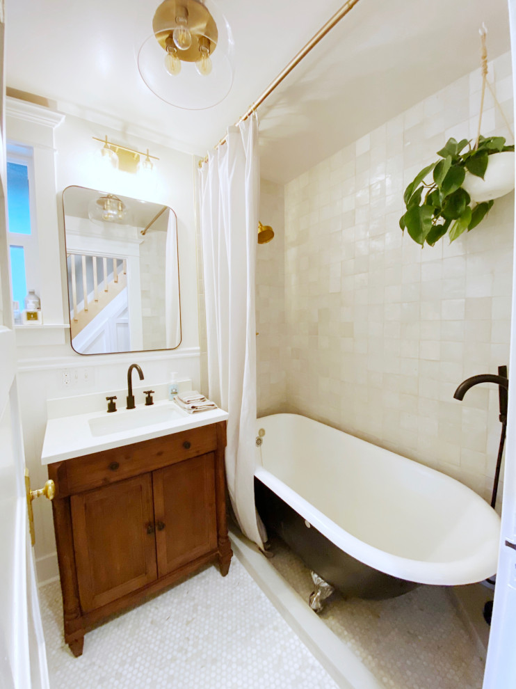 Inspiration for a small traditional ensuite bathroom in Seattle with recessed-panel cabinets, brown cabinets, a claw-foot bath, a shower/bath combination, a two-piece toilet, white tiles, terracotta tiles, white walls, mosaic tile flooring, a submerged sink, engineered stone worktops, white floors, a shower curtain, white worktops, a single sink, a freestanding vanity unit and wainscoting.