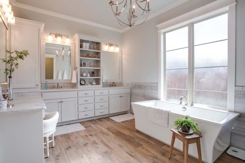 Exempel på ett stort modernt en-suite badrum, med skåp i shakerstil, ett fristående badkar, en kantlös dusch, grå kakel, cementkakel, grå väggar, klinkergolv i keramik, ett undermonterad handfat, marmorbänkskiva, vita skåp och brunt golv