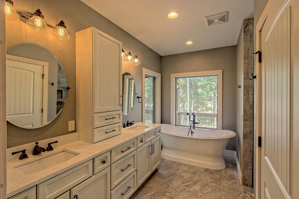 Inspiration for a mid-sized craftsman master gray tile and ceramic tile ceramic tile and gray floor bathroom remodel in Atlanta with recessed-panel cabinets, gray cabinets, a one-piece toilet, brown walls, an undermount sink, granite countertops and gray countertops