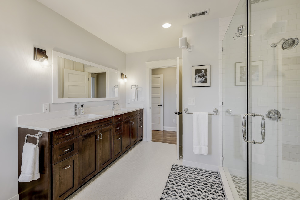 This is an example of a large traditional ensuite bathroom in Seattle with shaker cabinets, dark wood cabinets, a claw-foot bath, white walls, ceramic flooring, a submerged sink, engineered stone worktops, white floors, a hinged door, white worktops, double sinks, a built in vanity unit and a double shower.