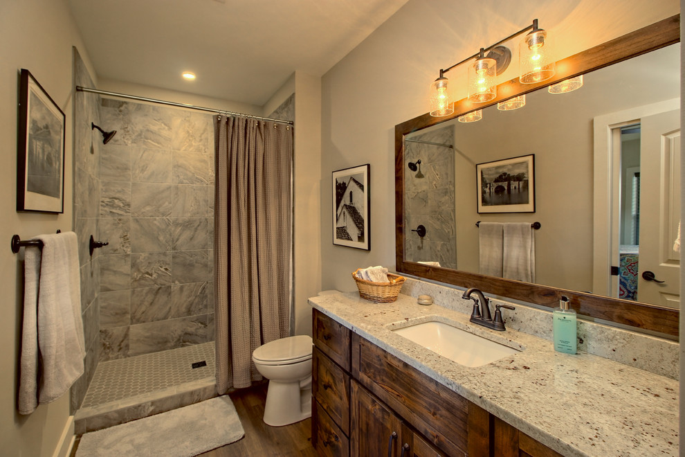 Example of a mid-sized arts and crafts 3/4 gray tile and ceramic tile ceramic tile and gray floor bathroom design in Atlanta with shaker cabinets, dark wood cabinets, a two-piece toilet, beige walls, an undermount sink, granite countertops and multicolored countertops