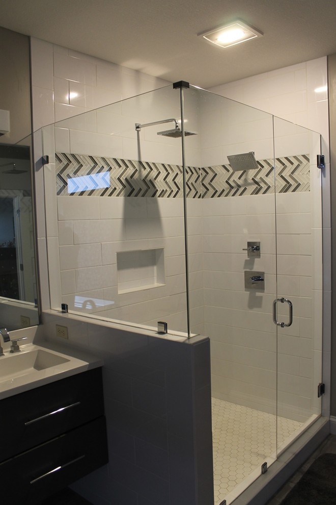 Inspiration for a mid-sized craftsman master subway tile corner shower remodel in Chicago with shaker cabinets, dark wood cabinets, gray walls, an integrated sink, solid surface countertops and a hinged shower door