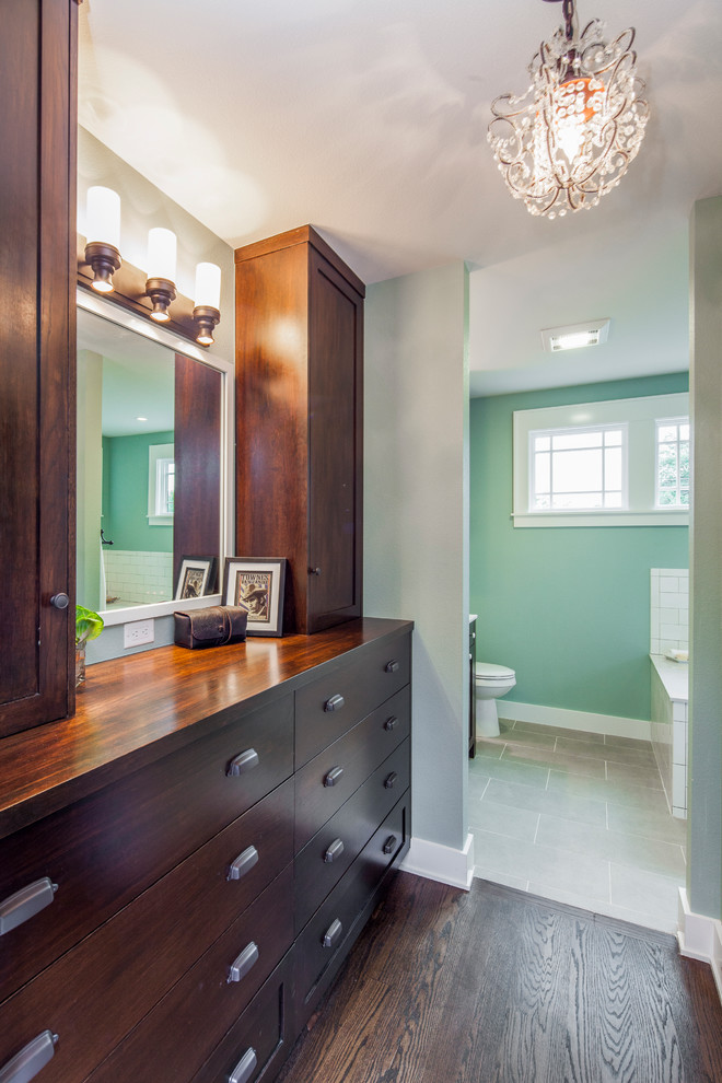 Idée de décoration pour une salle de bain principale tradition en bois brun de taille moyenne avec un placard avec porte à panneau encastré, un plan de toilette en quartz modifié et un mur vert.