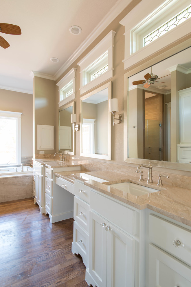 Inspiration for a large craftsman master beige tile and glass tile medium tone wood floor bathroom remodel in Dallas with an undermount sink, flat-panel cabinets, white cabinets, marble countertops and beige walls