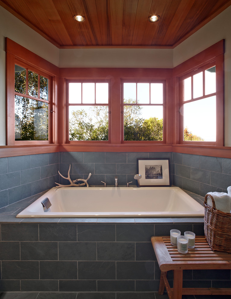 Example of a mid-sized arts and crafts master blue tile and stone tile alcove bathtub design in San Francisco with beige walls