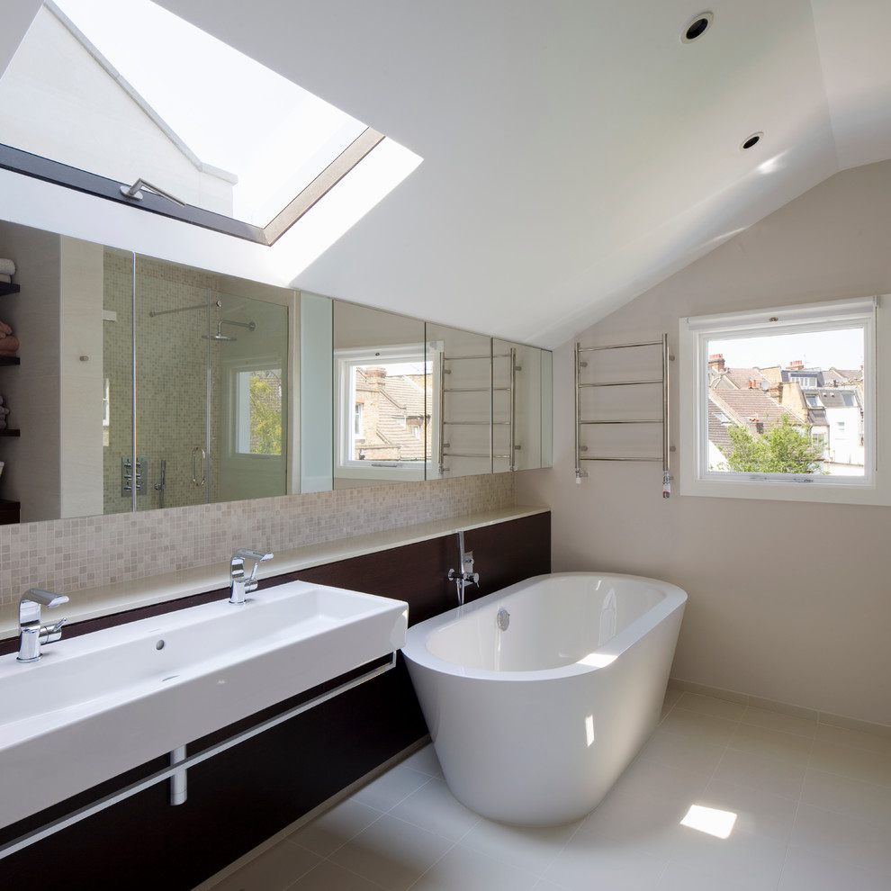 This is an example of a medium sized contemporary bathroom in London with a wall-mounted sink, dark wood cabinets, quartz worktops, a freestanding bath, a walk-in shower, a wall mounted toilet, beige tiles, porcelain tiles, beige walls and porcelain flooring.