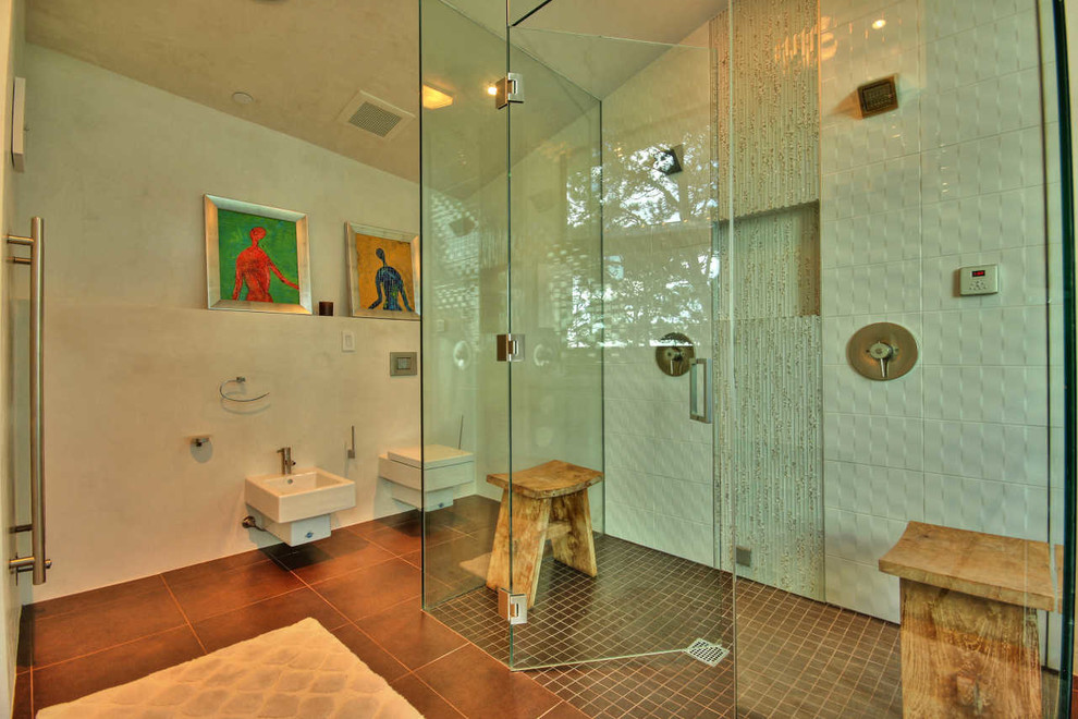 This is an example of a contemporary bathroom in San Francisco with a built-in shower, a wall mounted toilet and white tiles.