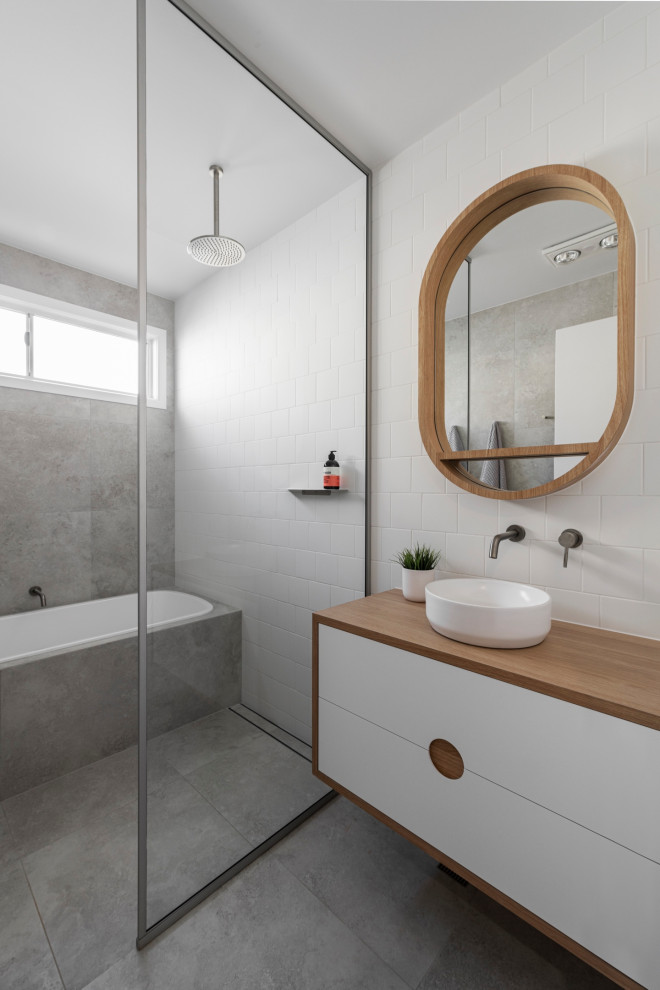 На фото: ванная комната в стиле модернизм с накладной ванной, настольной раковиной, столешницей из дерева и открытым душем