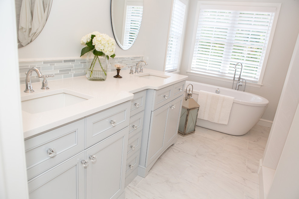 Bathroom - mid-sized transitional master gray tile and porcelain tile porcelain tile bathroom idea in Baltimore with an undermount sink, flat-panel cabinets, gray cabinets, quartz countertops, a one-piece toilet and gray walls