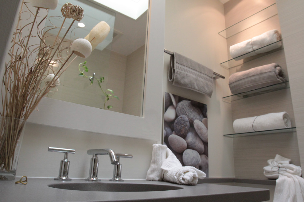 Photo of a medium sized contemporary ensuite bathroom in DC Metro with freestanding cabinets, grey cabinets, an alcove shower, a one-piece toilet, grey walls, pebble tile flooring, a submerged sink and stainless steel worktops.