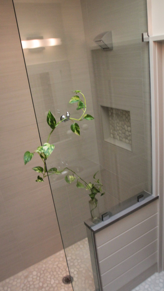 Alcove shower - mid-sized contemporary master pebble tile floor alcove shower idea in DC Metro with furniture-like cabinets, gray cabinets, a one-piece toilet, gray walls, an undermount sink and stainless steel countertops
