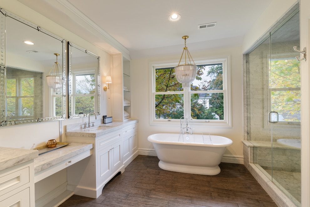 Mid-sized elegant master gray tile and marble tile dark wood floor and brown floor bathroom photo in Cincinnati with recessed-panel cabinets, white cabinets, white walls, an undermount sink, marble countertops and a hinged shower door