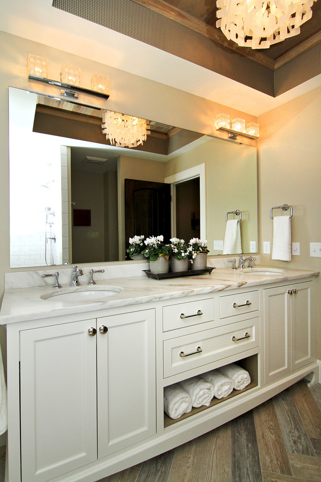 Example of a large transitional master dark wood floor claw-foot bathtub design in Minneapolis with shaker cabinets, white cabinets, gray walls, an undermount sink and marble countertops