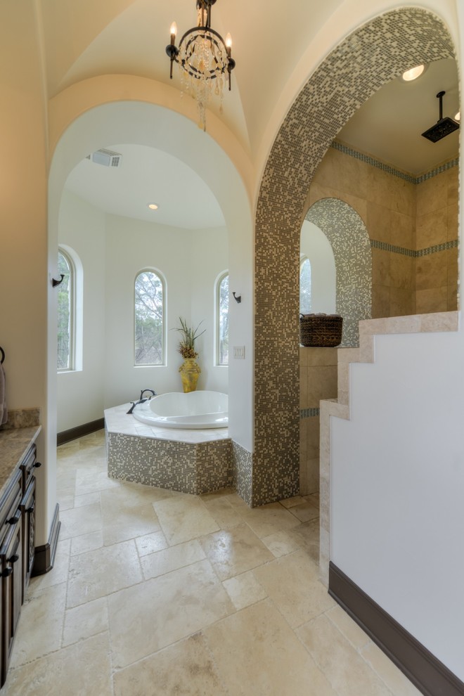Photo of a large mediterranean ensuite bathroom in Austin with medium wood cabinets, white walls, a built-in sink and solid surface worktops.