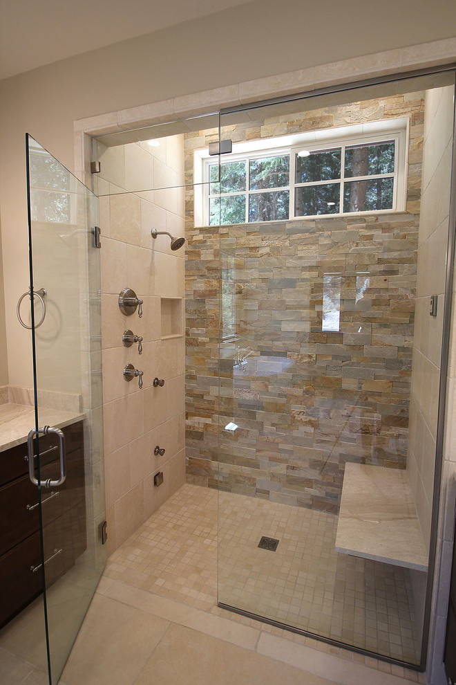 Example of a large transitional master beige tile and stone tile bathroom design in Albuquerque with dark wood cabinets, beige walls, an undermount sink, granite countertops, a hinged shower door and beige countertops